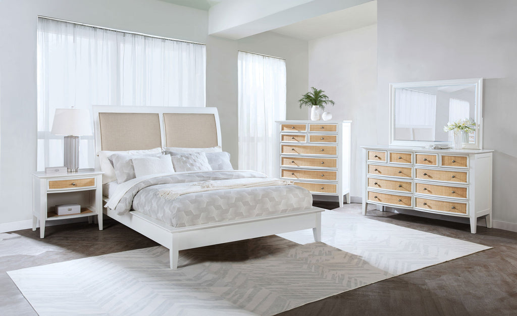 Modern bedroom with a bed, nightstands, dresser, and mirror. In a white walled bedroom