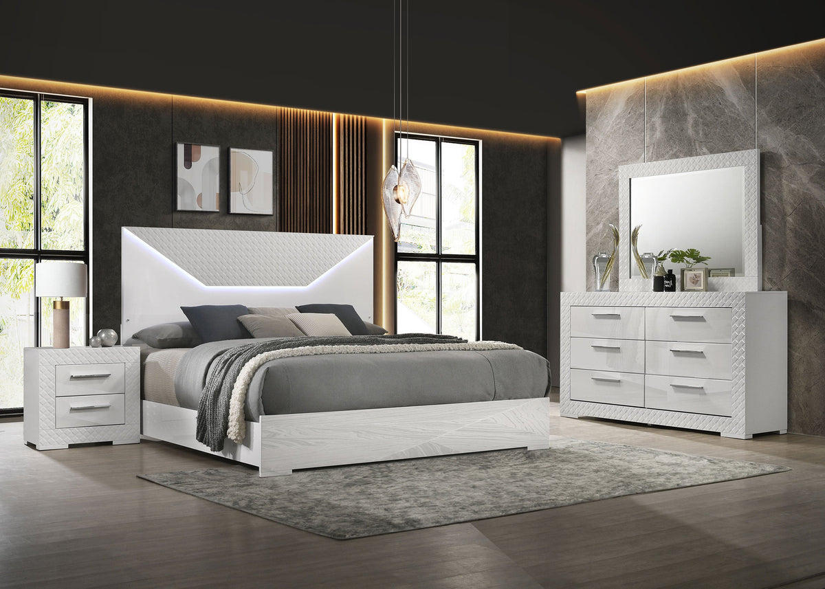 Modern bedroom with white furniture set including bed, nightstands, and dresser.