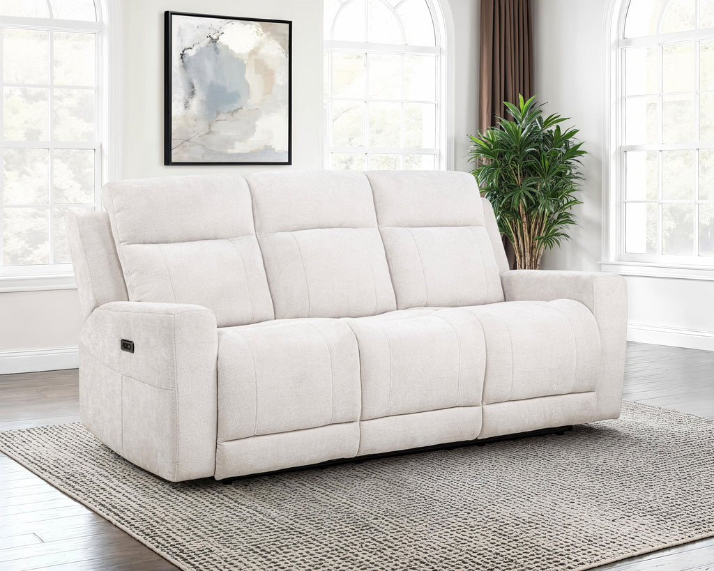 White sofa in a room with large windows and a plant