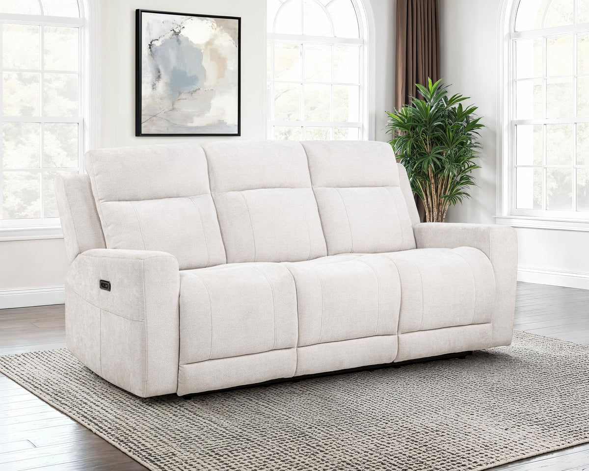 White sofa in a room with large windows and a plant