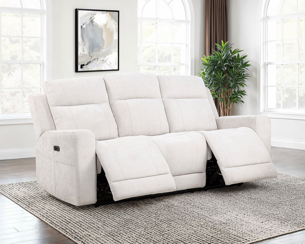 White recliner sofa in a living room setting with a plant and framed artwork.
