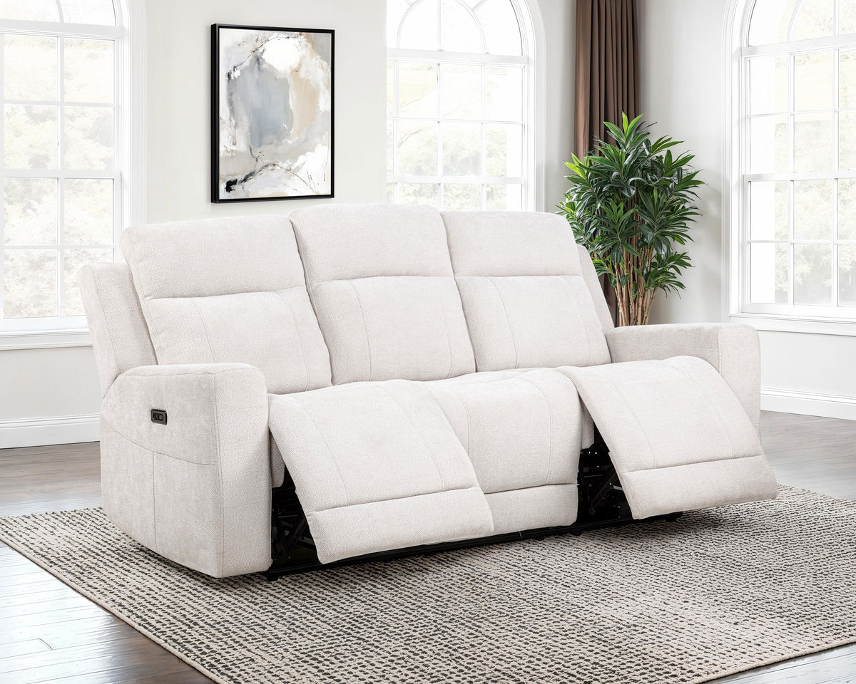 White recliner sofa in a living room setting with a plant and framed artwork.