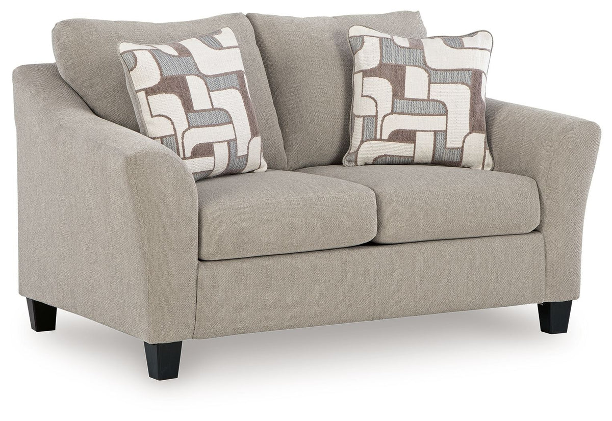 Beige sofa with patterned cushions on a white background
