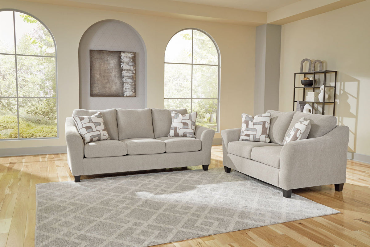 Two gray sofas with multi colored cushions against a cream wall living room